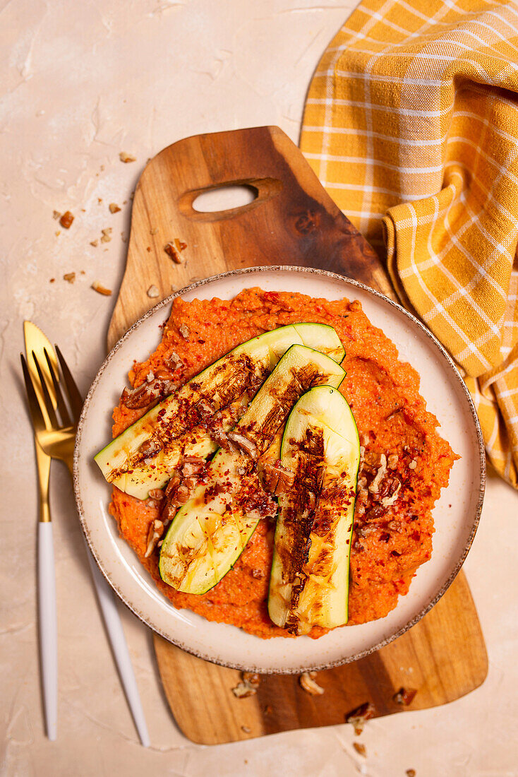 Red pepper hummus with grilled courgette and pecan nuts