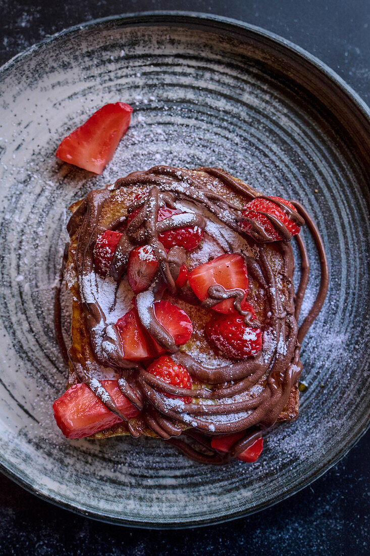 Waffle with strawberries and chocolate sauce