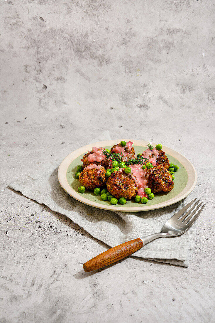 Meatballs with peas and cranberry sauce