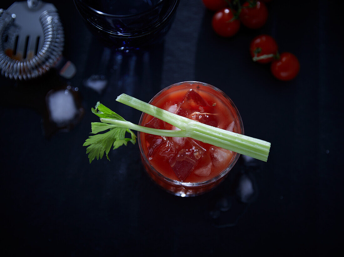 Bloody Mary with celery sticks and cherry tomatoes