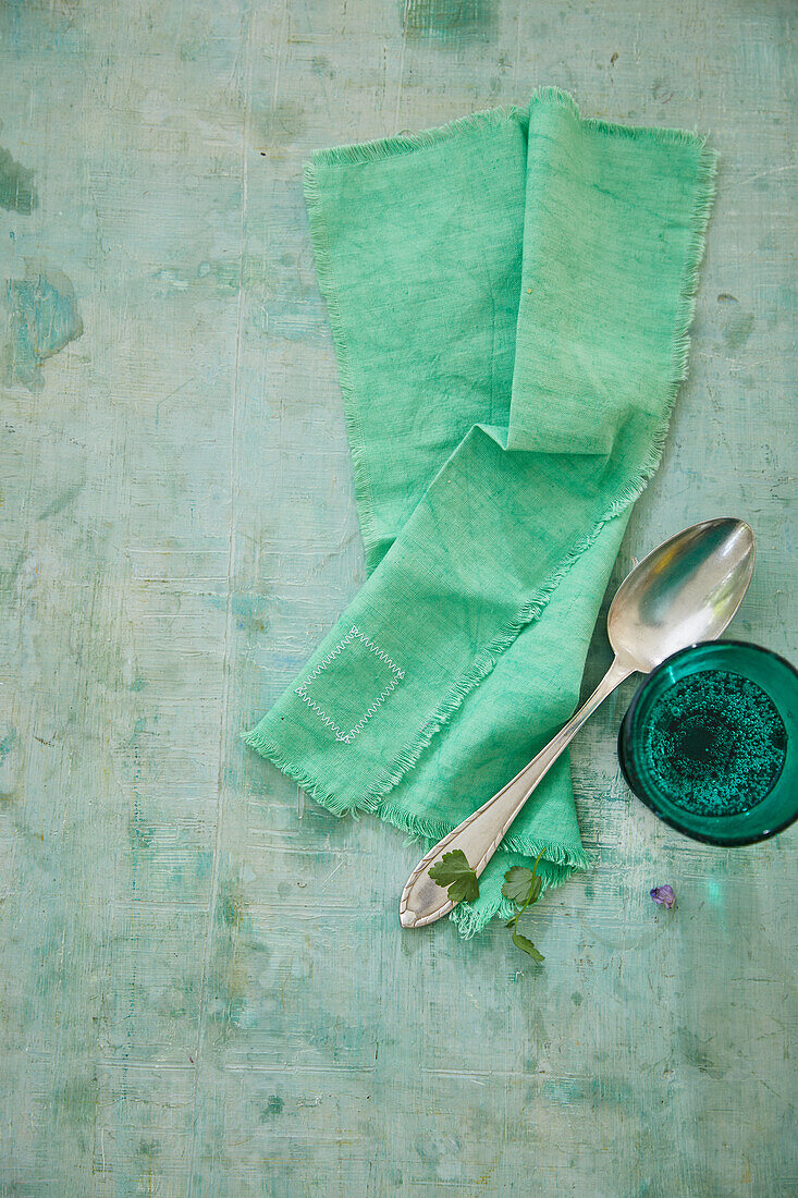 Mintfarbene Serviette, Esslöffel und Glas