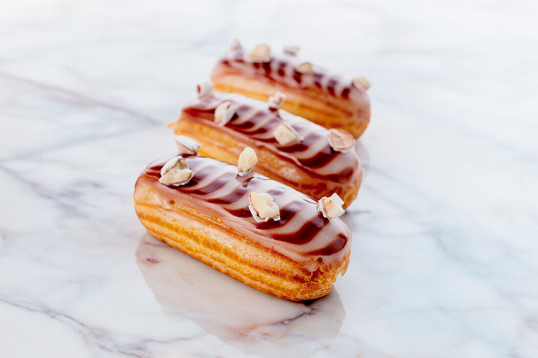 Eclairs with chocolate icing and nuts