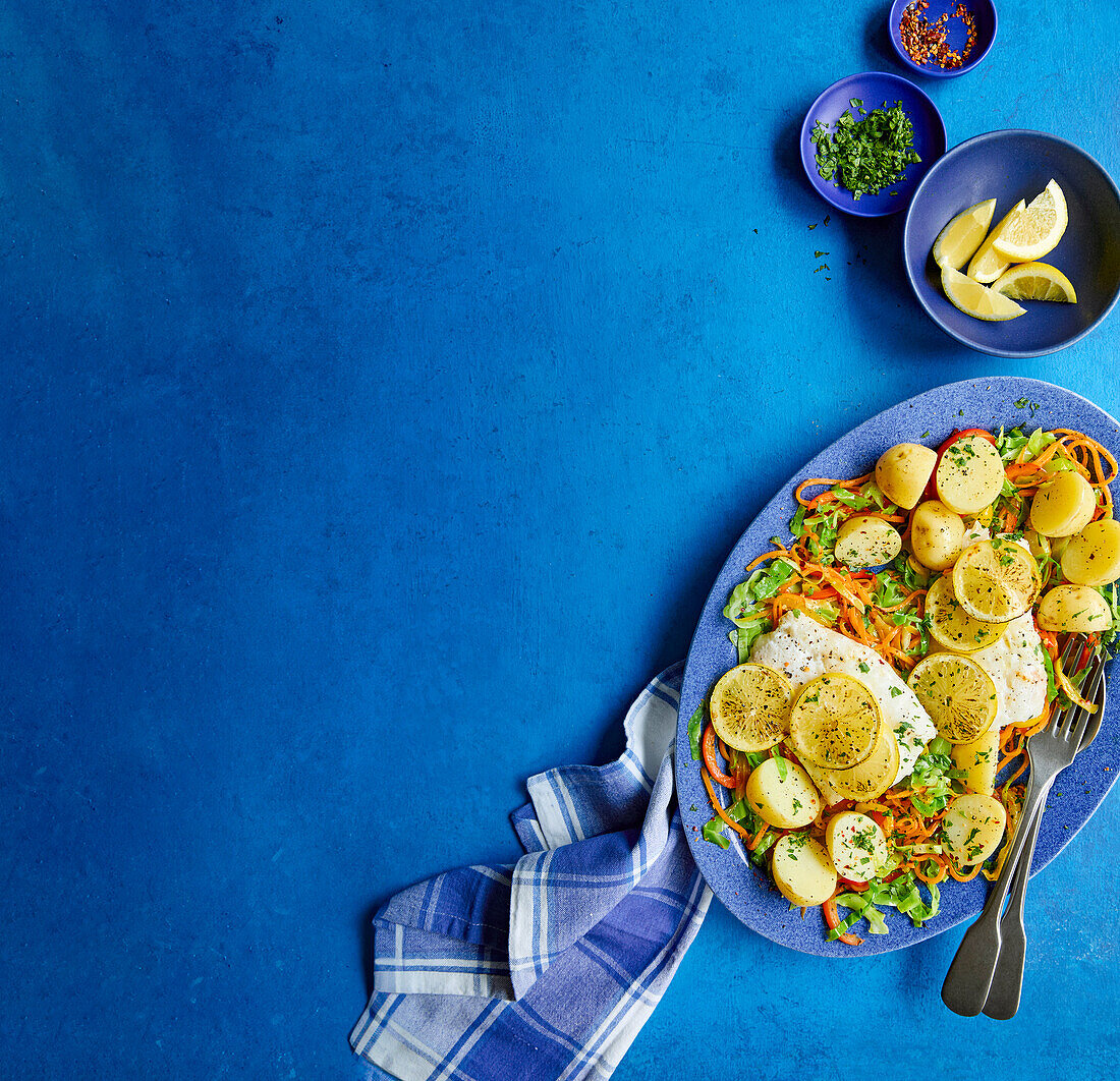 Lemon butter fish with sliced pointed cabbage and potatoes