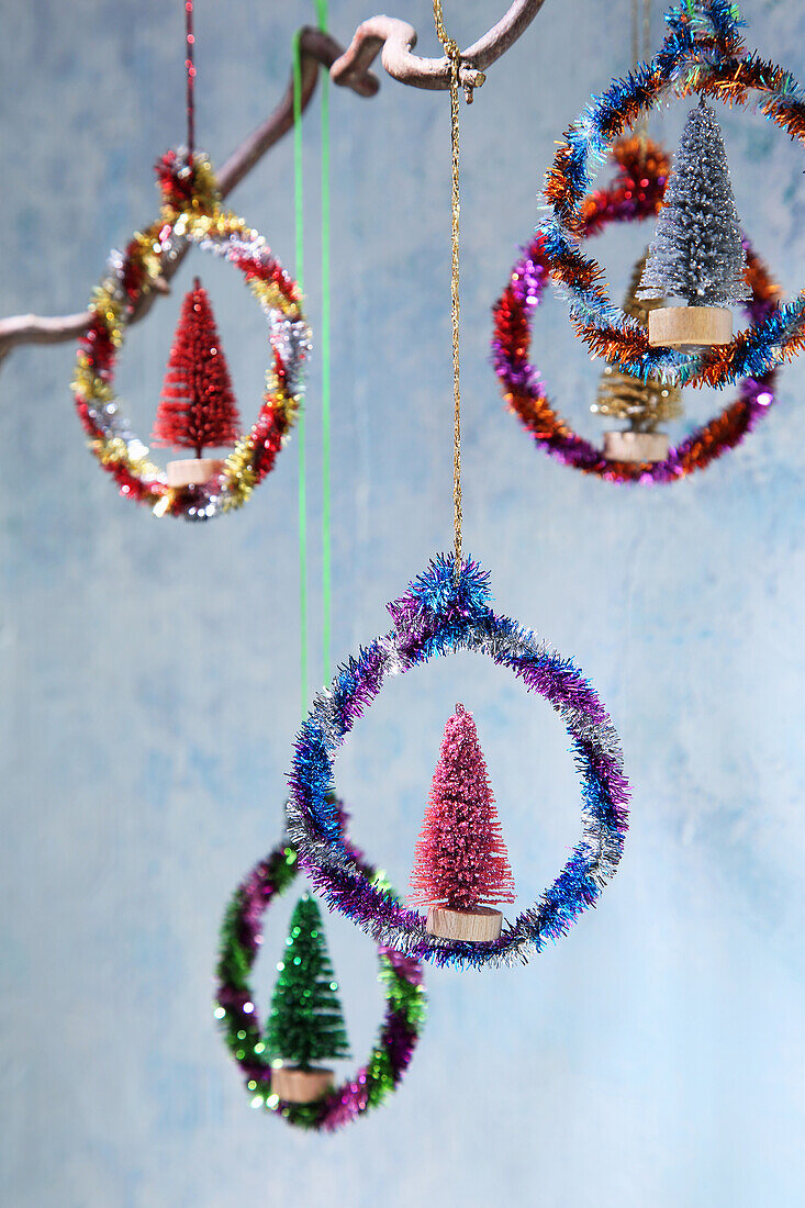 Homemade Christmas tags made from colourful, glittering chenille wire and decorative fir trees