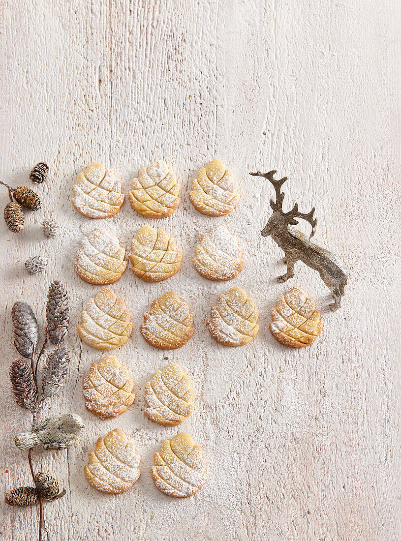 Pine cone-shaped almond biscuits dusted with icing sugar