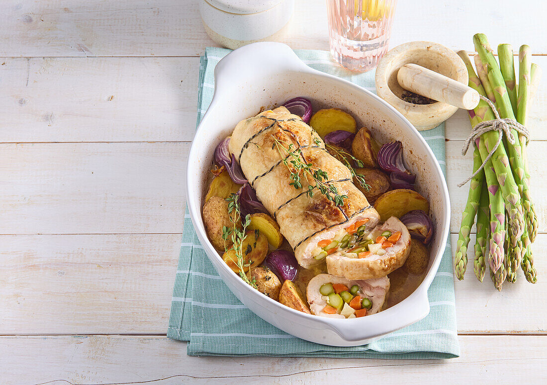 Stuffed chicken roulade with asparagus, carrots and jacket potatoes