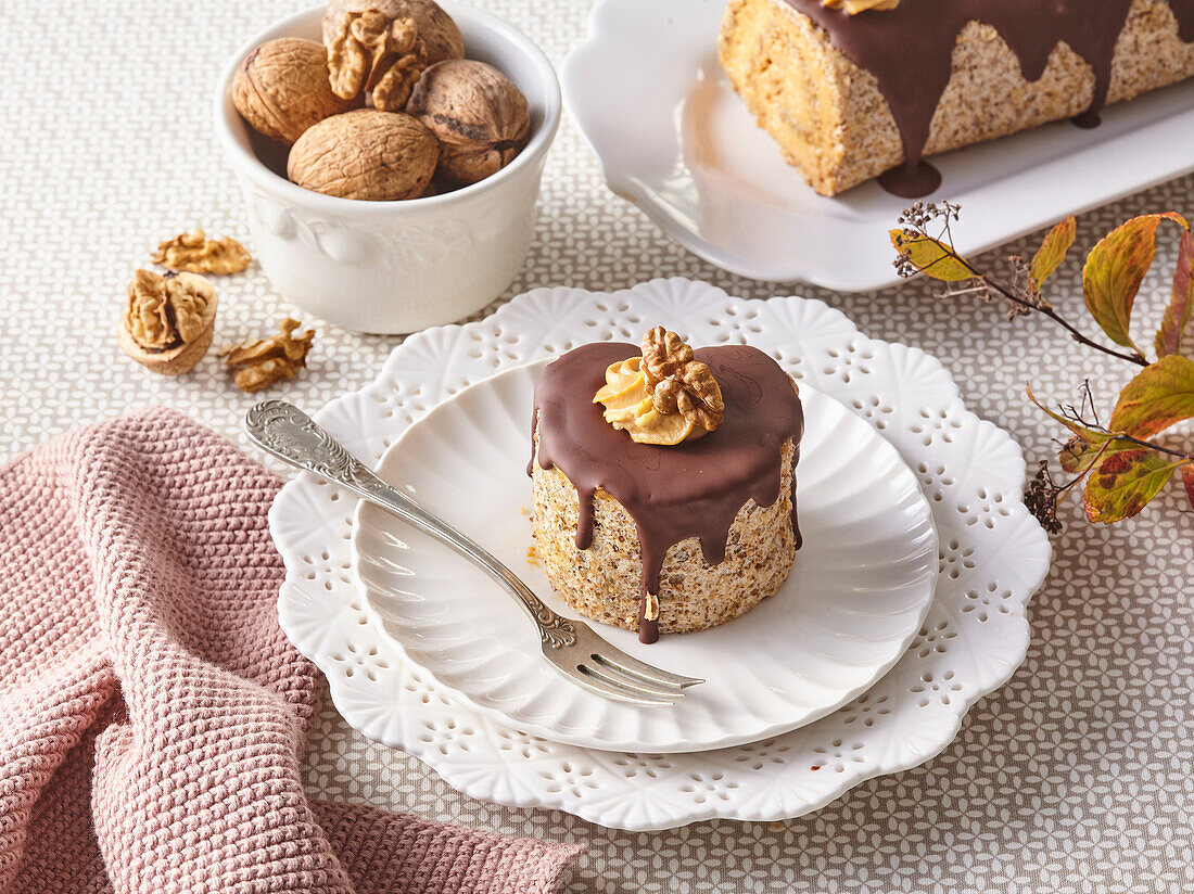 Nut roll with mascarpone cream and chocolate icing