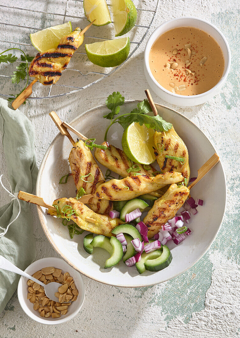 Chicken skewers with peanut sauce and vegetables