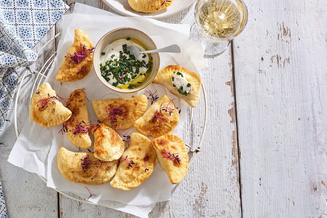 Deep-fried pierogi with sour cream dip