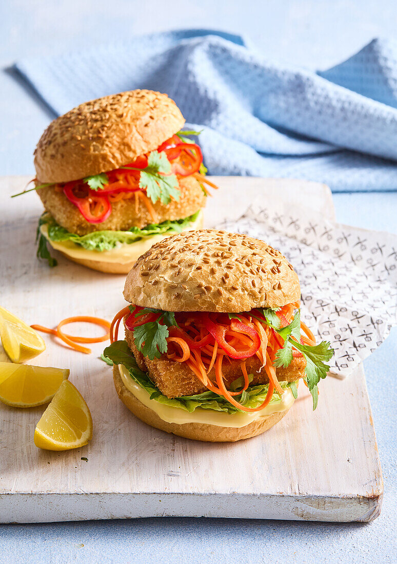 Fish burger with marinated carrots, peppers and coriander