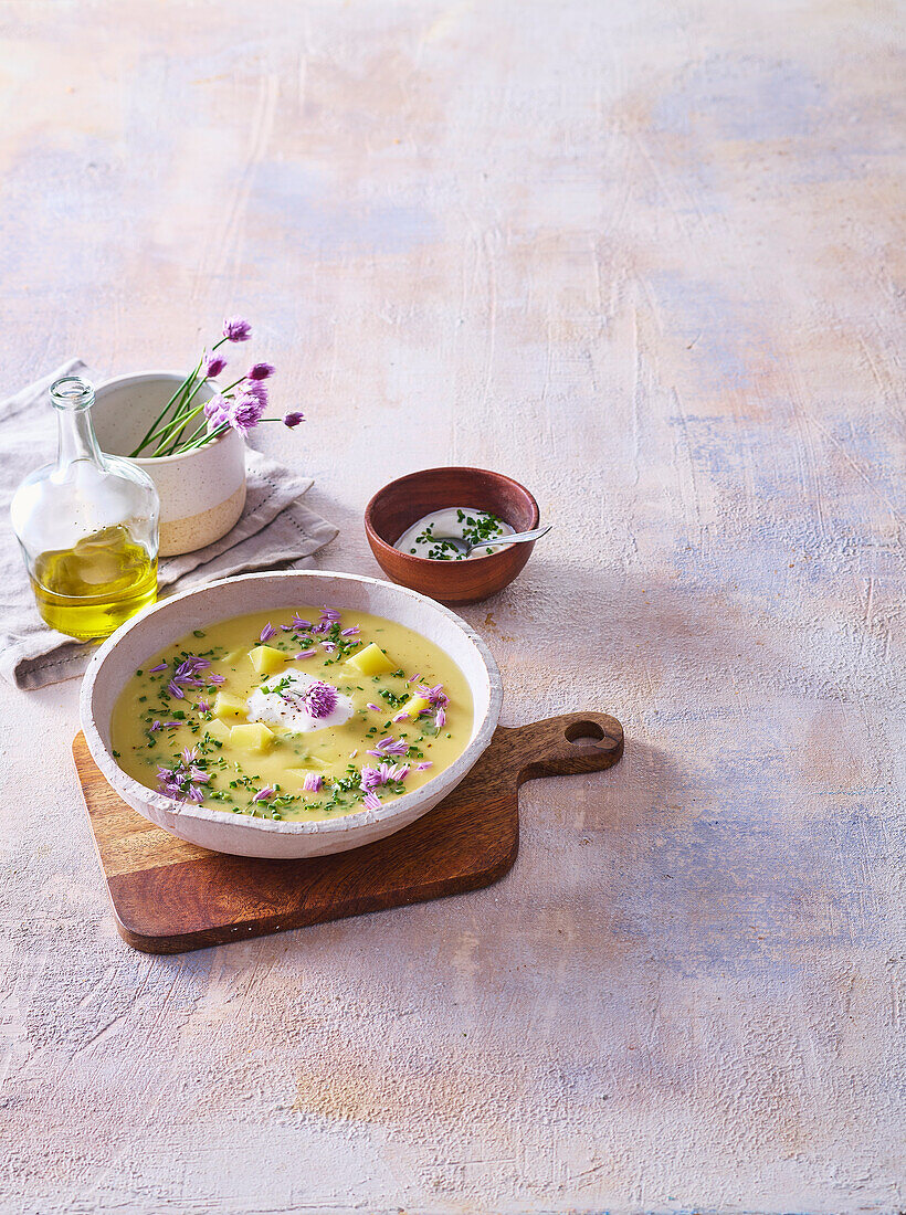 Potato soup with chives and cream topping