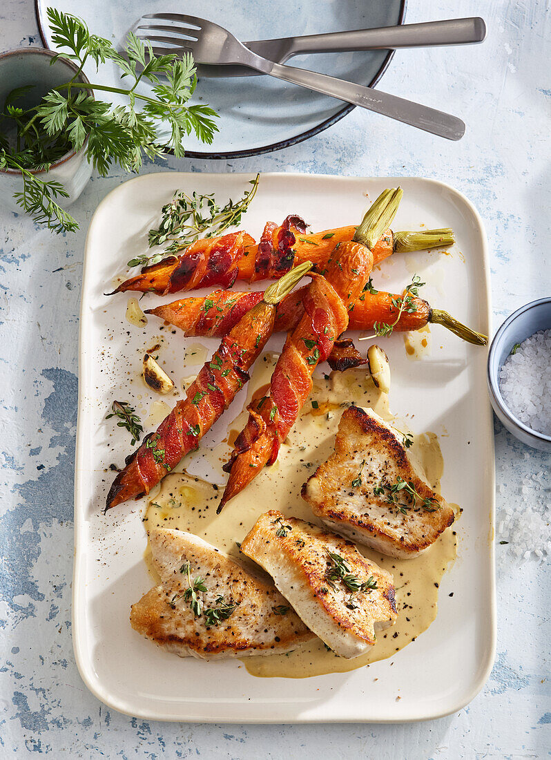 Turkey steak with glazed bacon and carrots