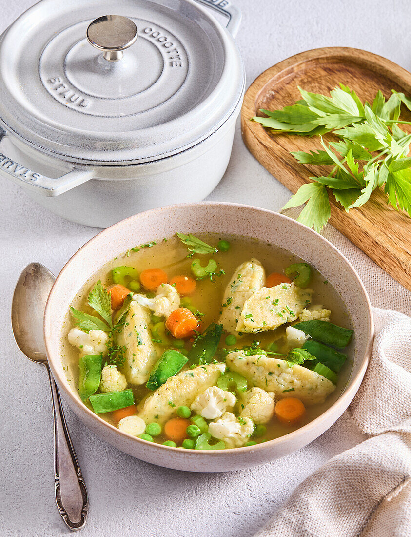 Vegetable soup with cheese gnocchi and fresh herbs