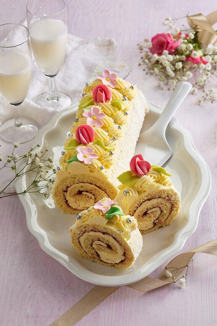 Wedding sponge roll with pudding and marzipan flowers