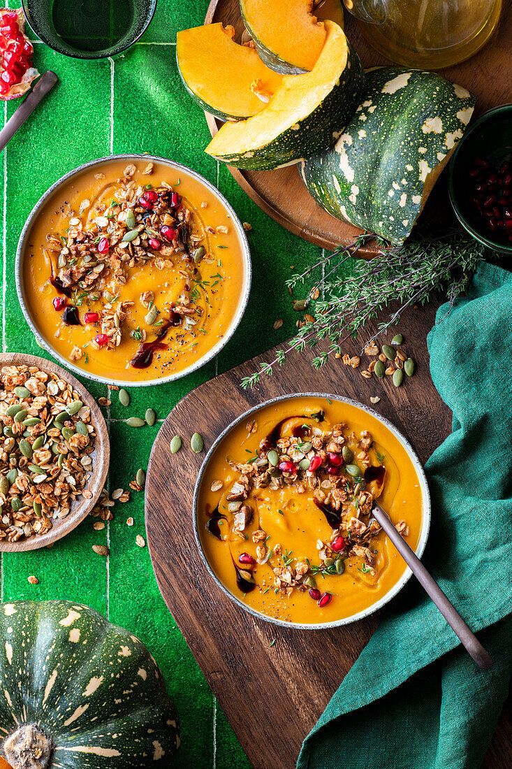 Pumpkin soup with savoury granola and pomegranate seeds