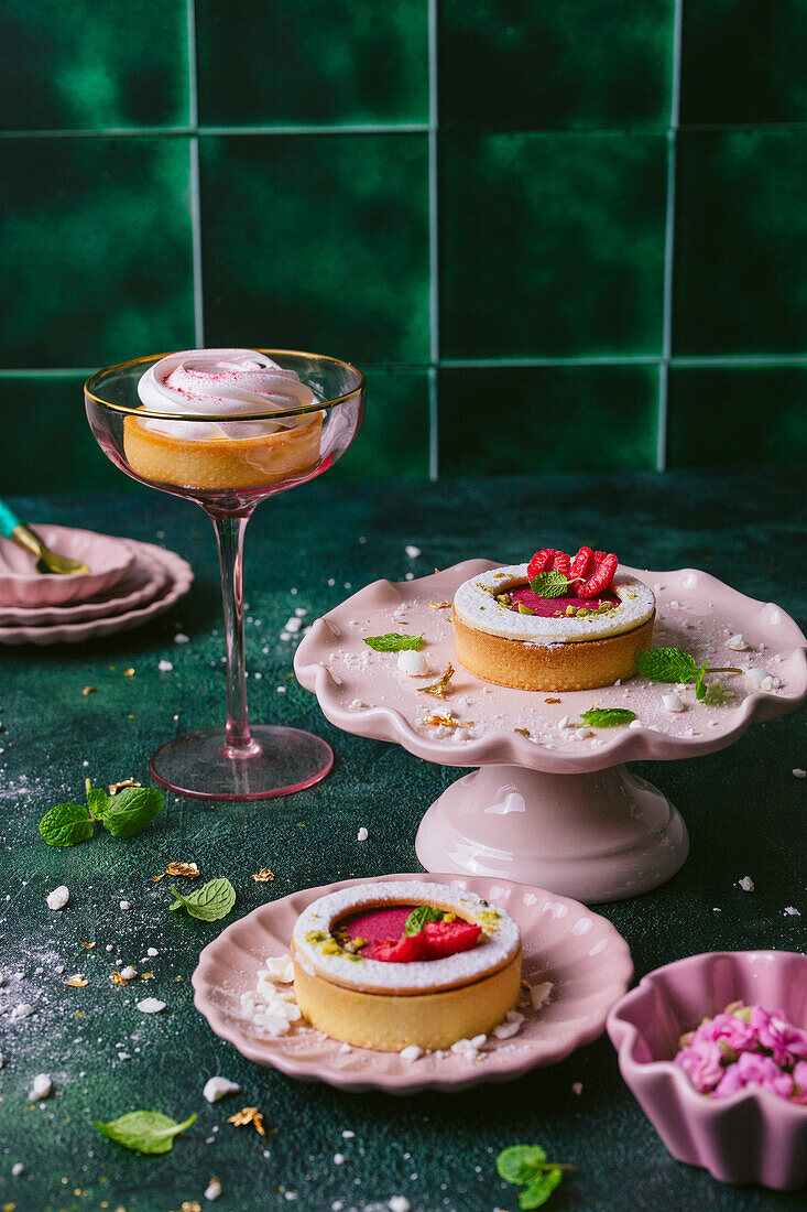 Mini tartlets with raspberry filling and mint, mini meringue tartlets