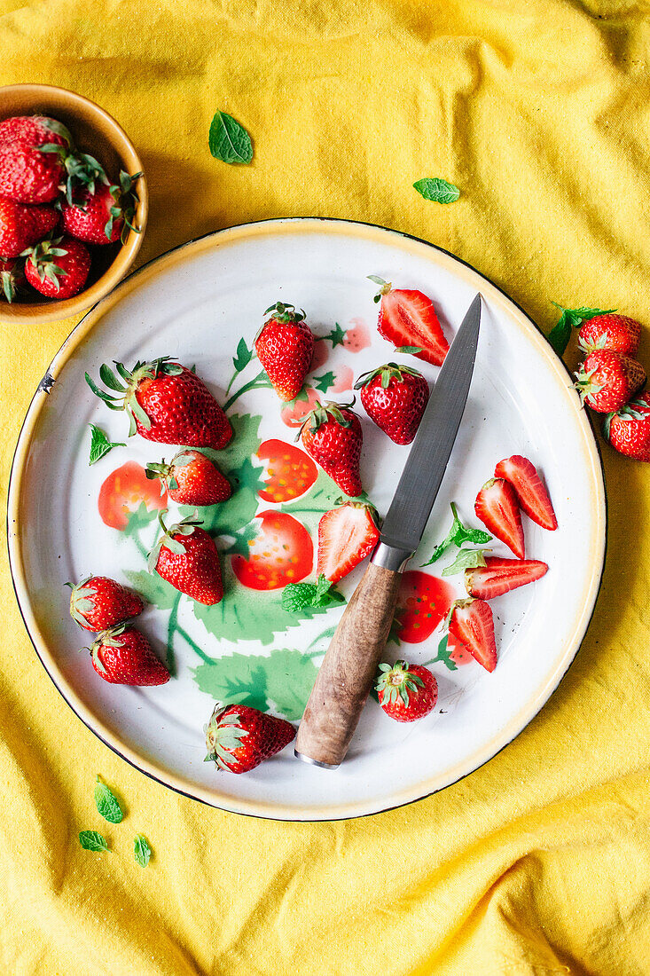 Fresh strawberries on a plate with a knife