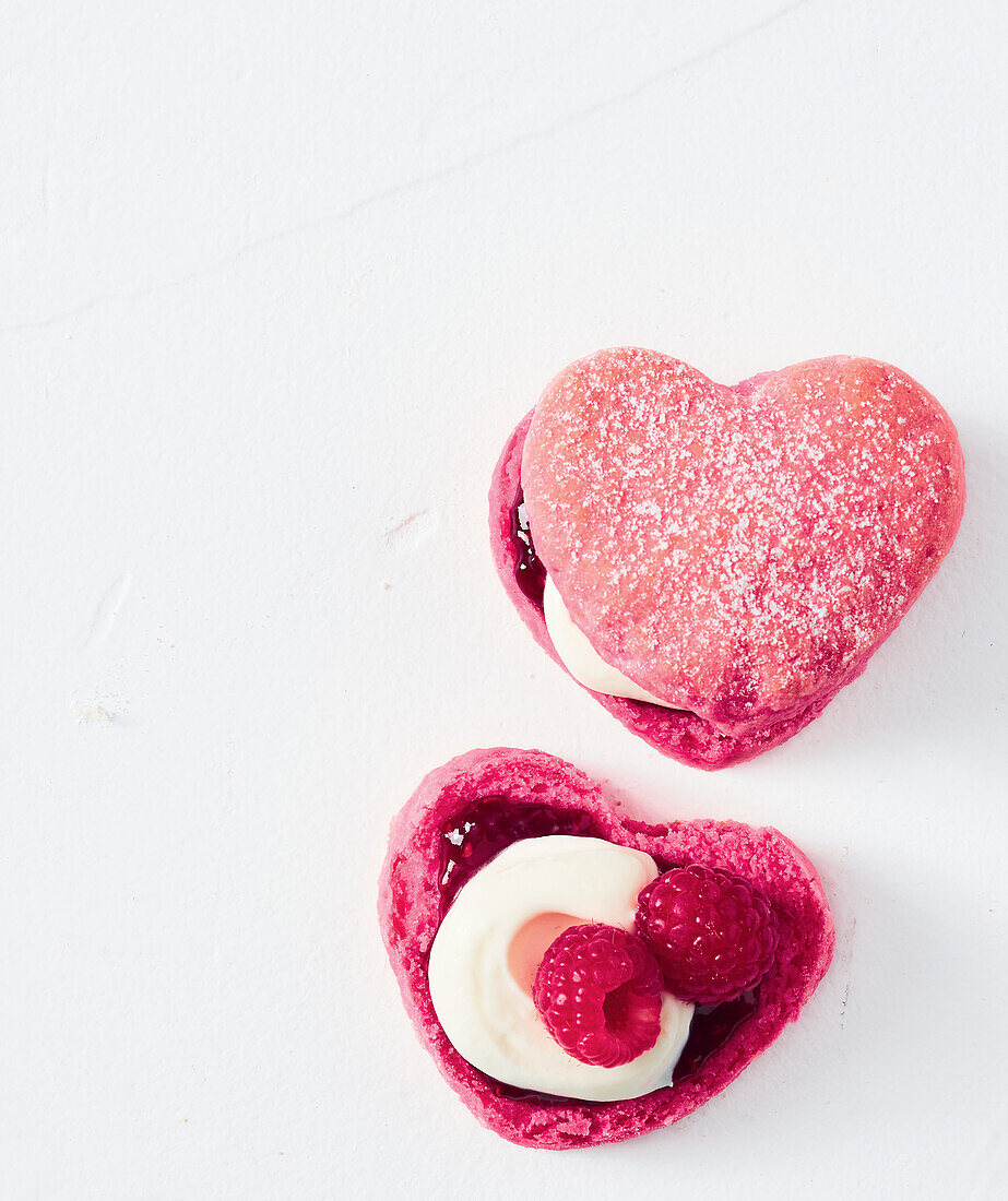 Heart-shaped raspberry macarons with cream filling