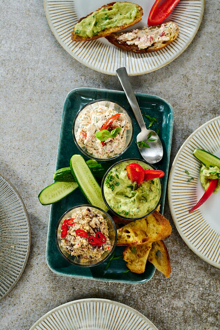 Three spreads with vegetables and toasted bread