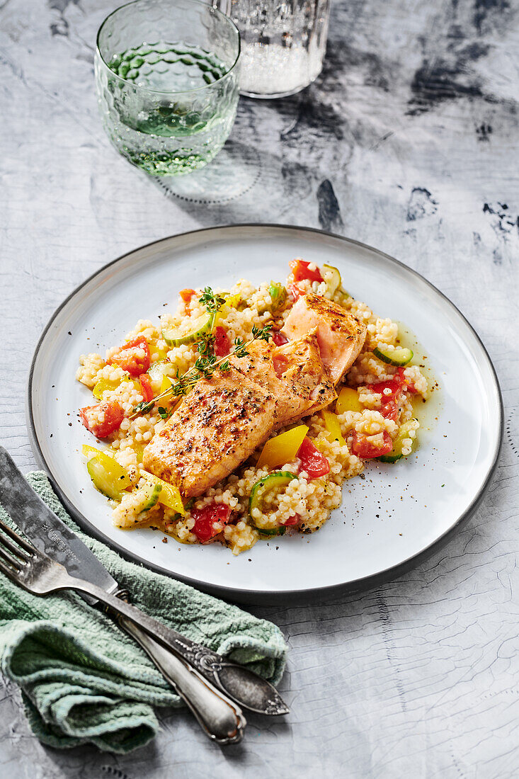 Pearl barley risotto with salmon and colorful vegetables