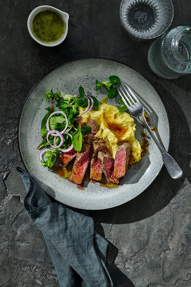 Hips steak with mashed potato and lamb's lettuce