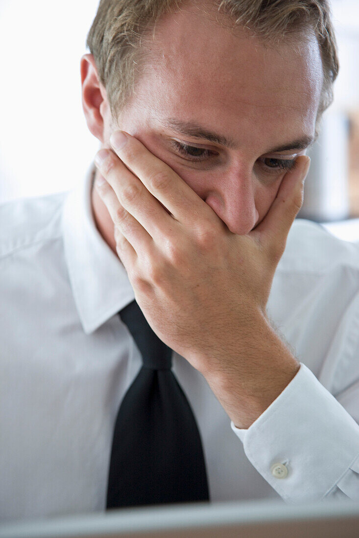 Close up of Businessman with Hand Covering Mouth