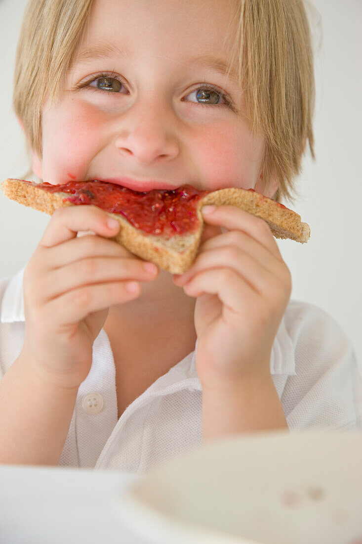 Boy Eating Jam on Toast