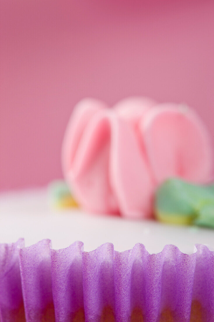 Purple Cupcake with Pastel Pink Flower Decoration