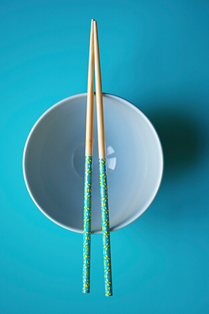 Empty Blue Bowl with Chopsticks