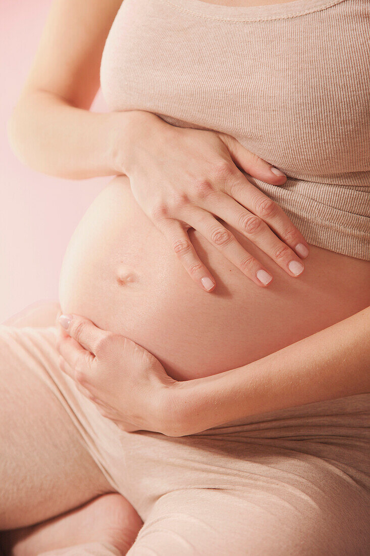 Therapeutic Massage, Pregnant Woman Massaging her Stomach