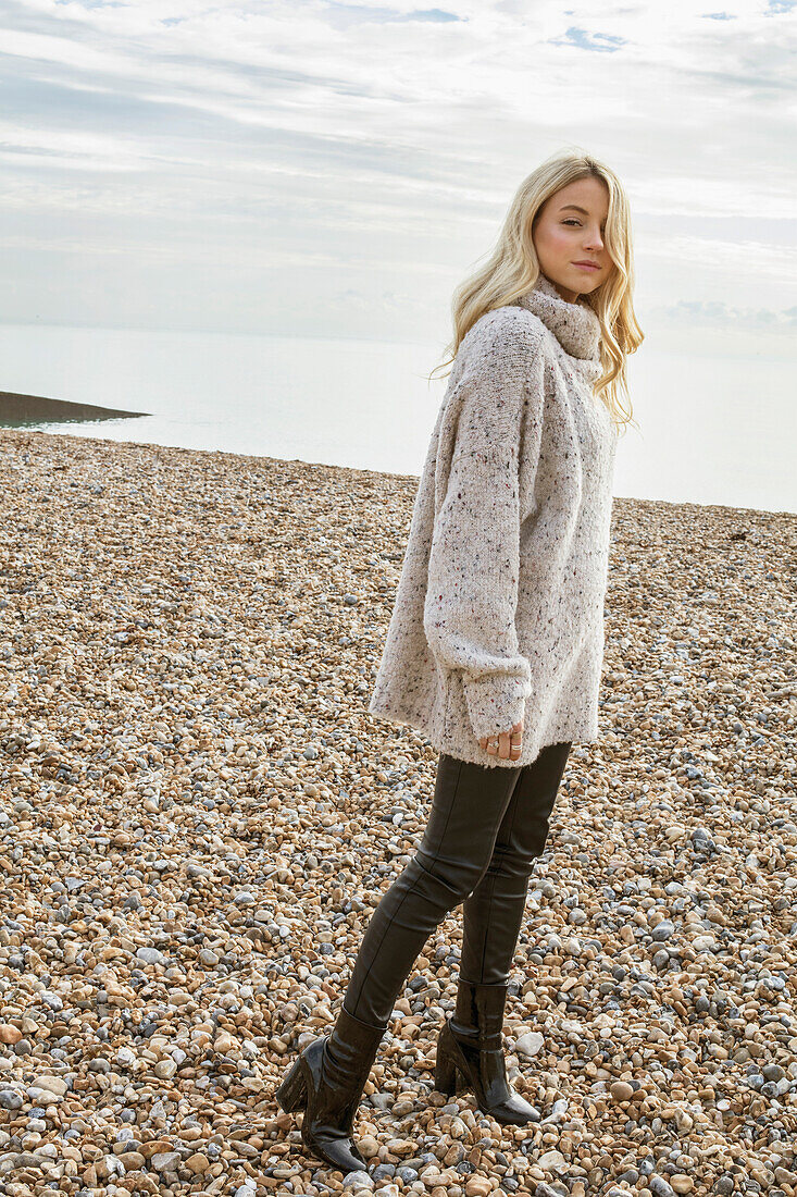 Young Woman on Pebble Beach in Winter