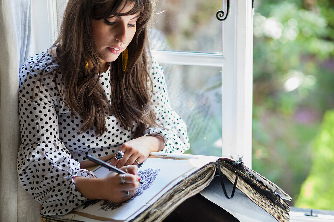 Woman Sitting by Window Drawing