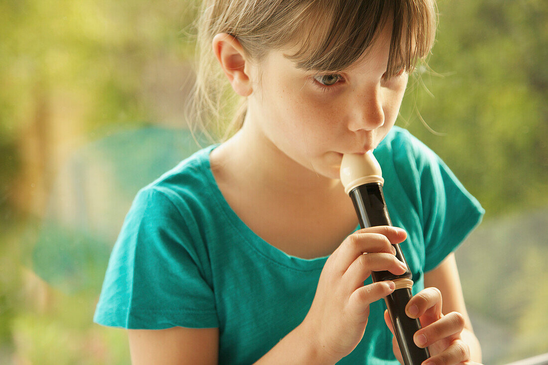 Young Girl Playing Recorder