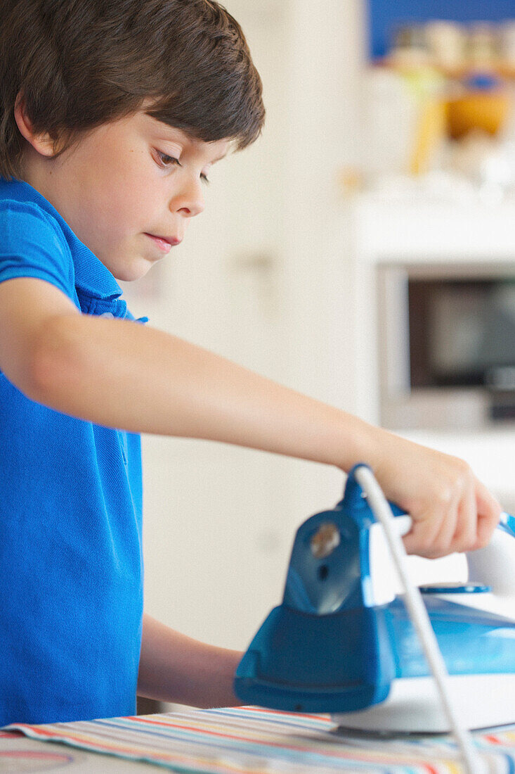 Close up of Young Boy Ironing