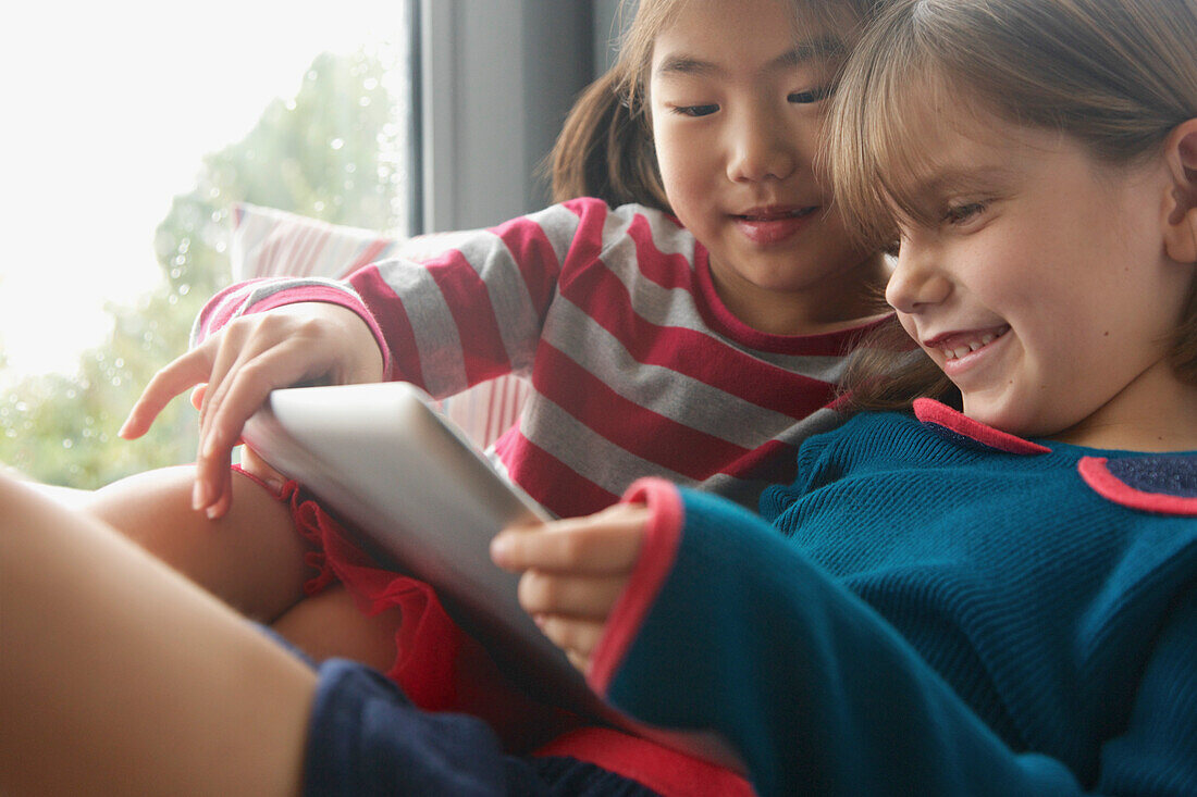 Young Girls Using Digital Tablet Smiling