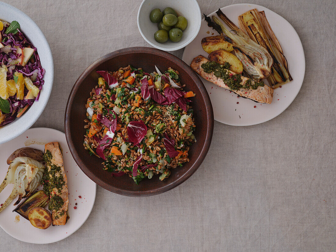 Still life table top view of healthy meal with grilled salmon, leeks, and spelt salad with radicchio