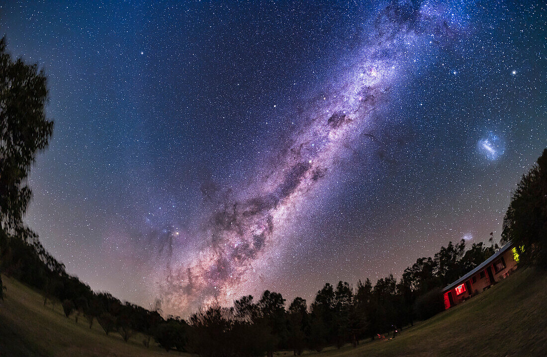 This frames the Australian aboriginal "Dark Emu" made of dark dust lanes in the Milky Way as it rises in the east. The spectacular southern reaches of the Milky Way from Centaurus to Carina shine above high in the south, including the Southern Cross. The dark Coal Sack beside the Cross is the head of the Emu. Her neck is the dark lane that splits the Milky Way starting at the star Alpha Centauri and extending down and into Scorpius, here rising above the trees.