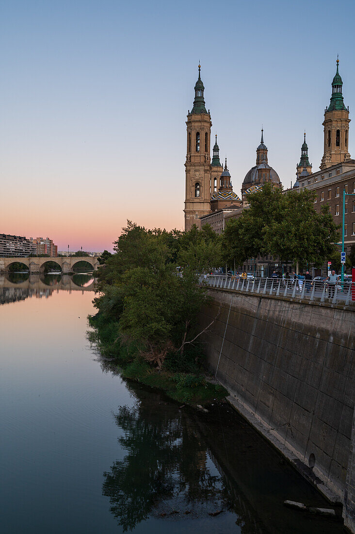 Cathedral-Basilica of Our Lady of the Pillar and the Ebro River bank at sunset, Zaragoza, Spain