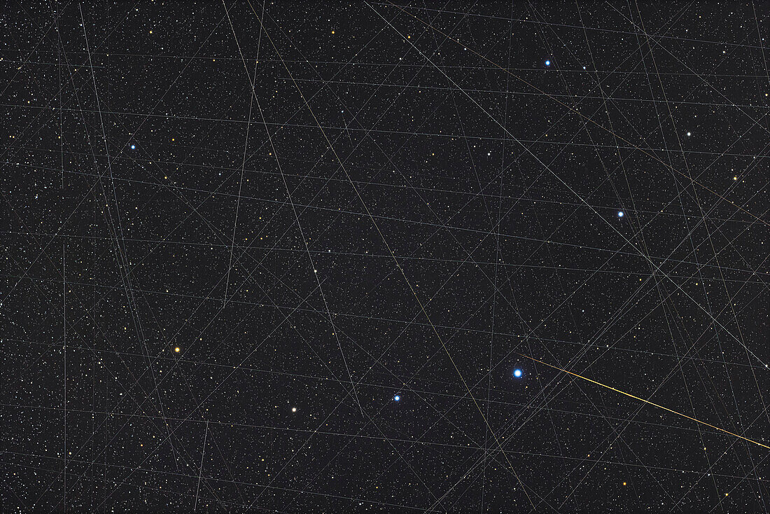 This is a demonstration of the crowded sky we now have, with all the trails being from Earth-orbiting satellites, with the exception of the tapered orange streak at lower right which is likely a meteor. This is a stack of 40 exposures taken over 70 minutes, layered to accumulate the satellite trails, not eliminate them, to show how many satellites crossed the field in the hour plus of the imaging. Are some SpaceX Starlinks? Perhaps, but there are many other satellites up there now.