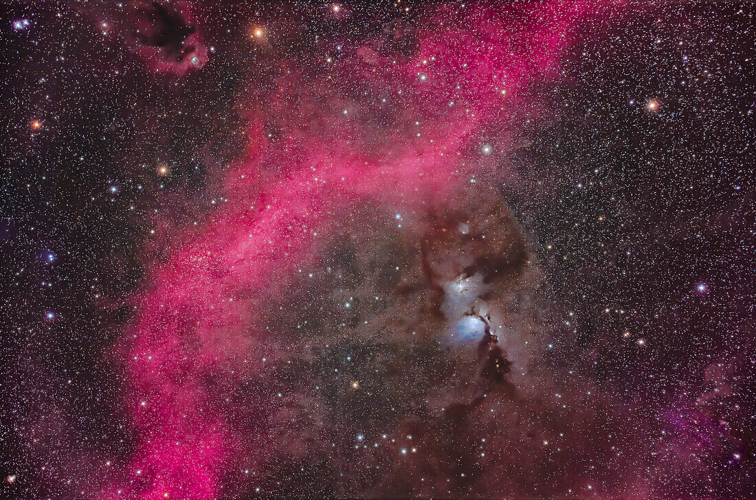 This is the bright reflection nebula complex that includes Messier 78 (the largest blue-white nebula) and NGC 2071 above it. They are set in a region of dark clouds of interstellar dust, and framed by the red-magenta arc of the emission nebula known as Barnard's Loop, aka Sharpless 2-276. The small reflection nebula at upper left on the edge of another dark cloud is van den Bergh 62. The large star cluster left of centre on the edge of the Loop is NGC 2112.