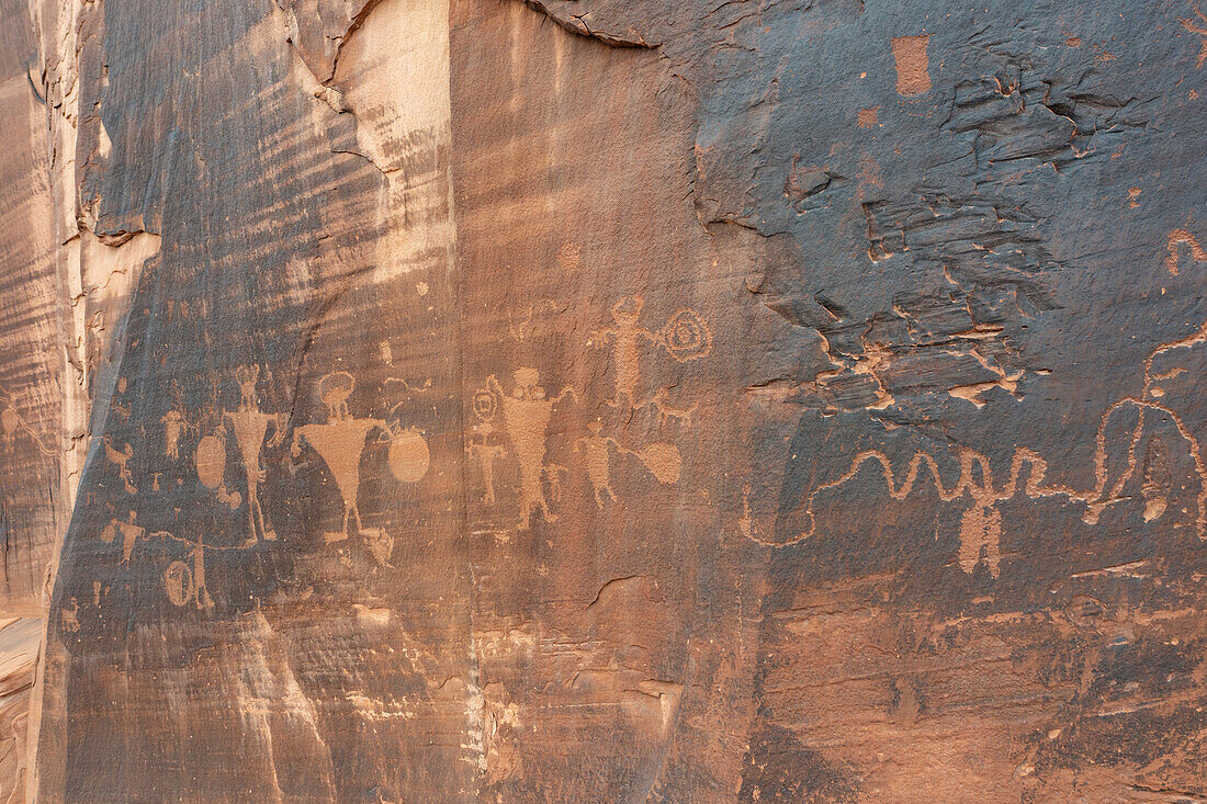 Prähistorische Petroglyphen der Fremont-Kultur, die Krieger mit Schilden auf einer Sandsteinwand in der Nähe von Moab, Utah, darstellen.