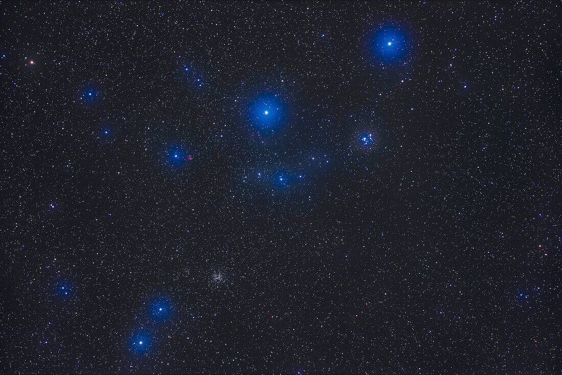 The pair of small open star clusters in northern Orion: NGC 2194 at lower left, a rich cluster, and NGC 2169 at upper right, a loose cluster but with stars arranged in two groups making it look like a number 37 or an XY letter pair. The small red nebula at left above NGC 2194 is Sharpless 2-269.