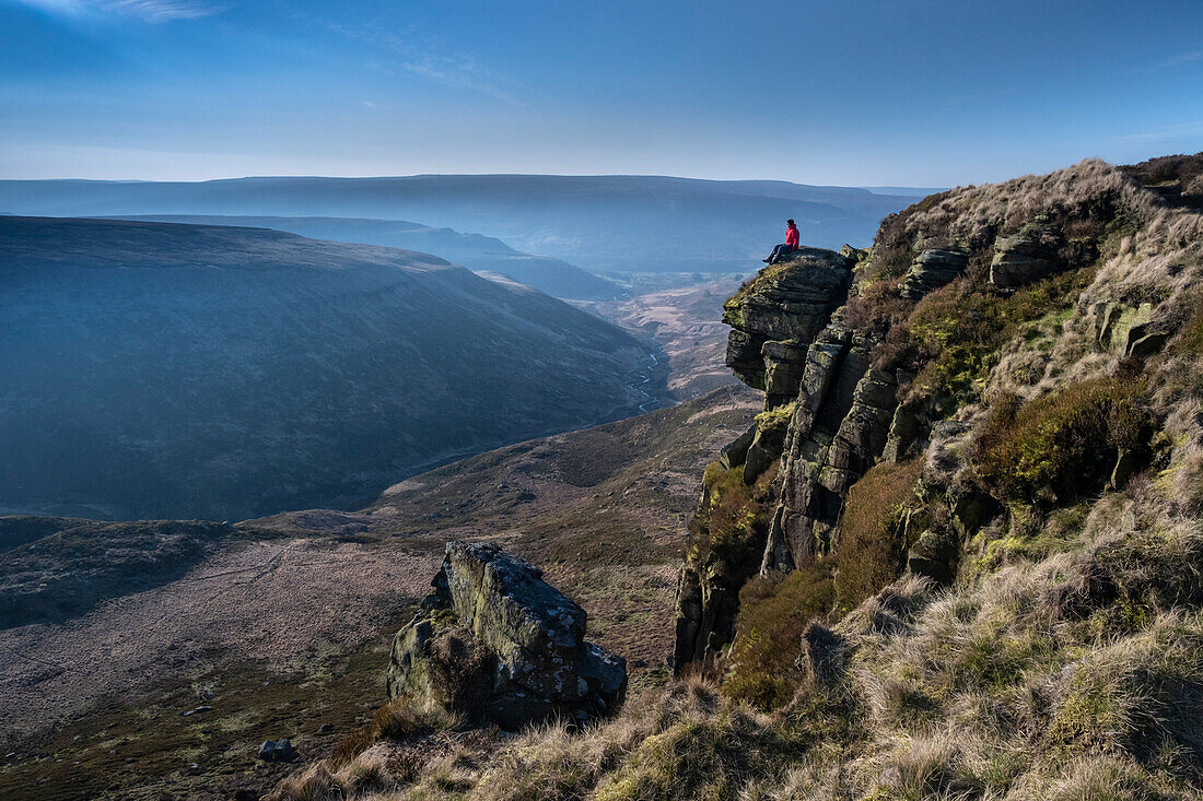 Walker looking over Crowden Great Brook valley from Laddow Rocks, Peak District National Park, Derbyshire, England, United Kingdom, Europe