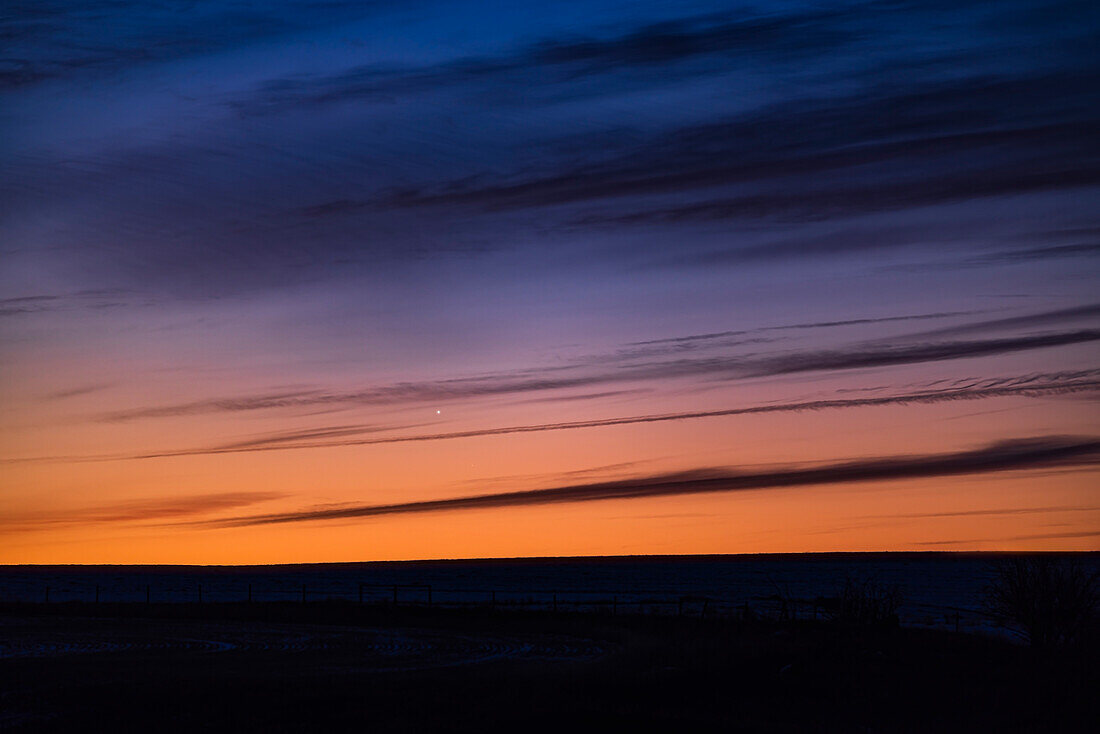 This is the close conjunction of bright Venus (at magnitude -3.9) and much dimmer Mars (at magnitude +1.3) as the pair was rising at dawn on February 22, 2024. They were about 40 arc minutes apart this morning.