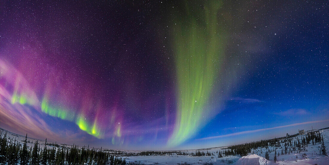 A panorama of weak Kp1-level auroral arcs in the moonlight, on February 15, 2024, from the deck of the Churchill Northern Studies Centre, Manitoba. This is an example of the kind of low-level aurora that is almost always present at locations like Churchill under the main auroral oval. The northerly lower arc did not appear until close to midnight, as is typical for weak displays. It was then joined by the broad dim arc at centre reaching overhead. Note the dark streaks in the wide arc.