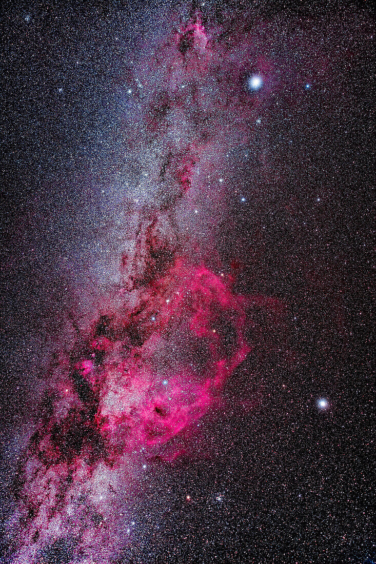 This frames the southern Milky Way from Canis Major and its bright star Sirius at top, to Carina and its bright star Canopus at bottom. Sirius and Canopus are the first and second brightest stars in the night sky, respectively. The major feature here is the massive Gum Nebula, perhaps a remnant from a nearby (1500 light years away) but ancient supernova. Or it might be a more normal emission nebula created as part of star formation and stellar winds. Its 36º-wide extent sprawls across Puppis (just below Canis Major) and Vela (to the left of Canopus). It was discovered by Australian astronomer 