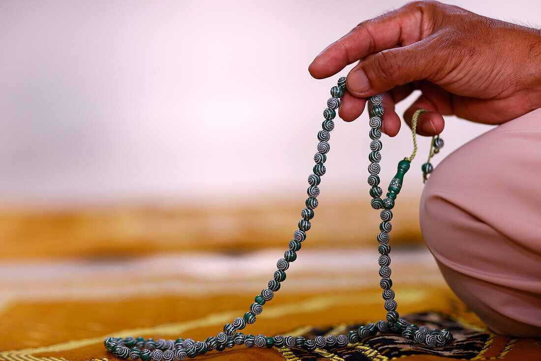 Close-up of hand of Muslim man praying with Islamic prayer beads, Chau Doc, Vietnam, Indochina, Southeast Asia, Asia