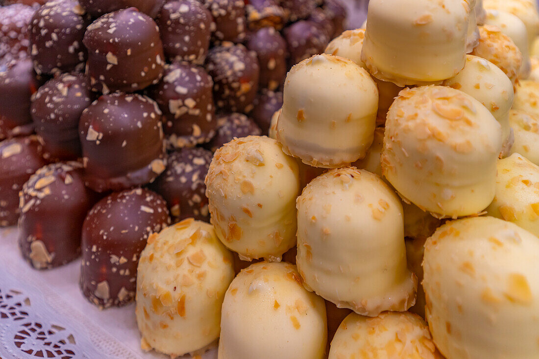 View of chocolates on Christmas Market stall in Victoria Square at dusk, Birmingham, West Midlands, England, United Kingdom, Europe