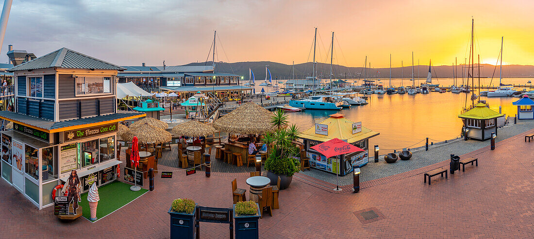 View of golden sunset, boats and restaurants at Knysna Waterfront, Knysna, Western Cape Province, South Africa, Africa