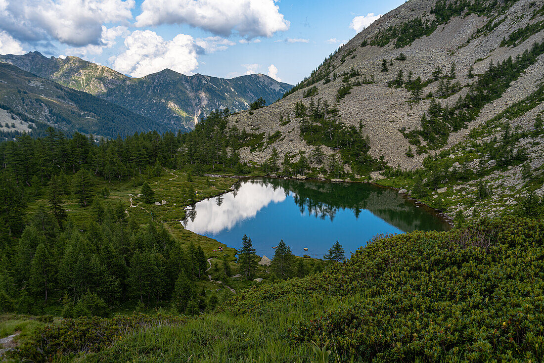 Pristine alpine lake reflecting the blue sky, Alpine Crossing, Italian Alps, Italy, Europe